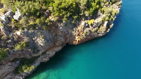 Athletic Young Man Jumping From Cliff Into Ocean Sea Water Muscular Adventure Extreme Sports Lifestyle Hobby Vacation Clear Beach Activity Aegean side of Turkey Mediterranean peninsula Marmaris