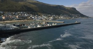 4K summer day aerial drone footage of spectacular Kalk Bay harbour, boats, lagoon with beach. Kalk Bay is Cape Town residential suburb on False Bay of Cape Peninsula, Western Cape, South Africa