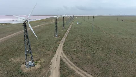 Nikolaev, Ukraine-September 28, 2018:Wonderful bird`s eye of wind energy mills installed on a big offshore farm between two country roads at the Black sea in Ukraine in summer