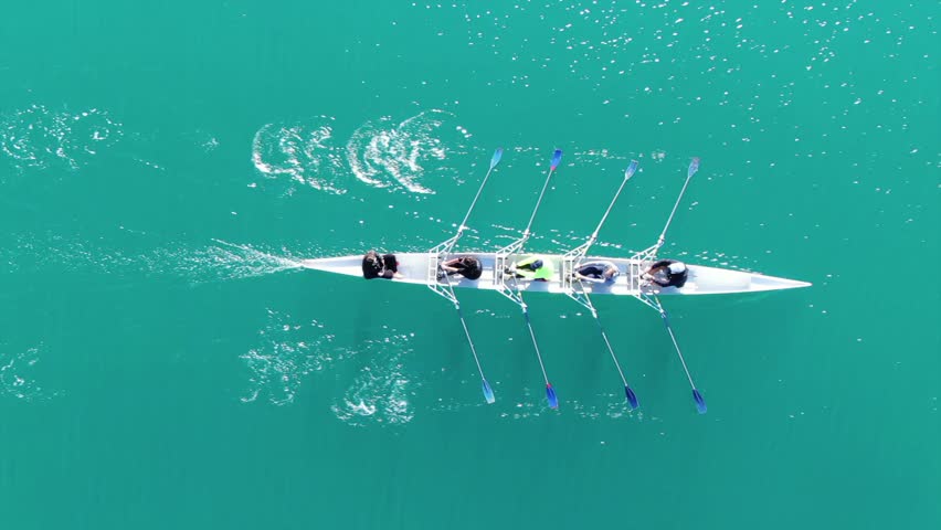 Aerial drone bird's eye view video of sport canoe operated by team of young women in emerald clear waters | Shutterstock HD Video #1021950031