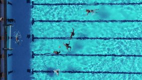 Aerial drone top view video of people competing in waterpolo in turquoise water pool