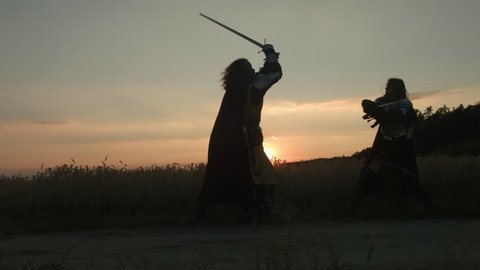 Fight at sunset. Wide shot.