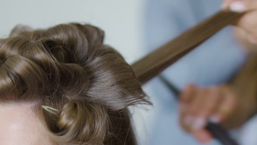 Close up of hairdresser fixing a bride's hair before the wedding | Shutterstock HD Video #1021967179