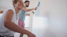 Couple Decorating Room In New Home Painting Wall Together - Powered by Shutterstock - Get 15% off with code: PIKWIZARD15