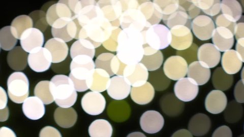 Abstract white yellow bokeh lights on road street in city night light background, decoration in soft for greeting card backdrop with glitter sparkle blurred circles. 4k