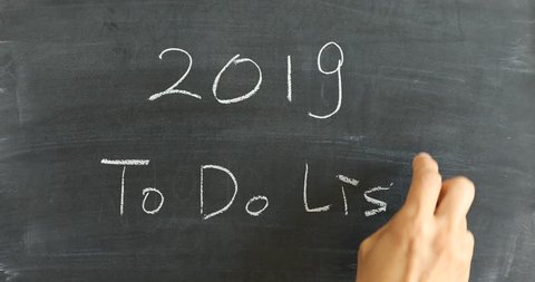 Hand writing To Do List below 2019 on blackboard with chalk