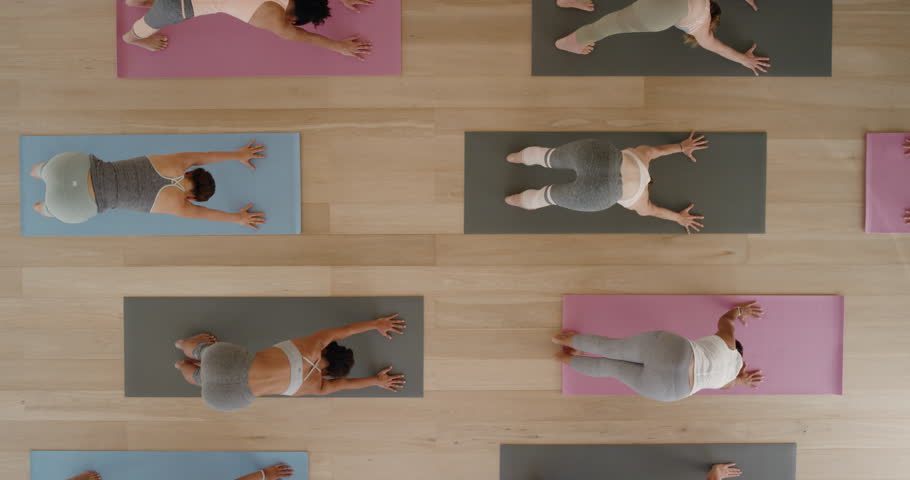 Above view yoga class healthy women practicing warrior pose enjoying fitness lifestyle exercising in gym | Shutterstock HD Video #1021975762