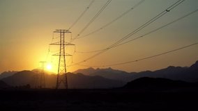 Power Line High Voltage Electricity Pylons at Sunset. 4K Video Clip