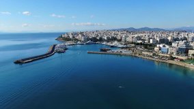 Aerial birds eye view video taken by drone of Marina Zeas, a small crowded circular port with boats docked near Peiraeus, Attica, Greece