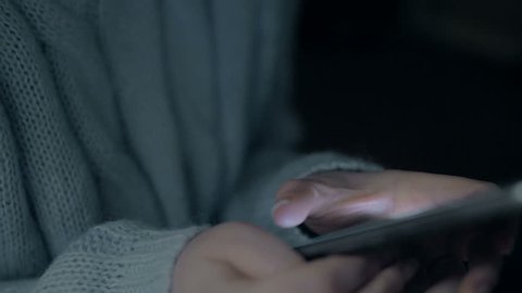 Young girl hold smartphone in night. Close up slow motion 4k footage.