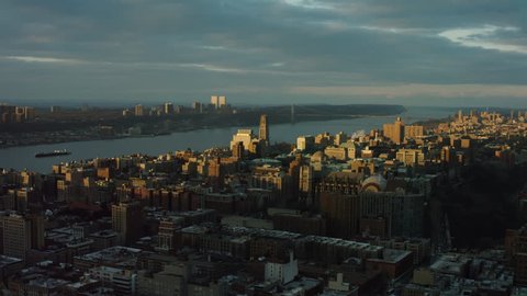 Aerial view of buildings near the Hudson River in Upper Manhattan, New York City, dim sunset lighting. Wide shot. 4k shot with a RED camera.