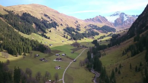 4k aerial view Swiss Alps remote Fermel valley which is an avalanche prone area with rural agriculture farms and steep hills and dangerous slopes and no tourism