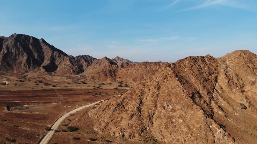 AERIAL. Top view of Road between mountains in UAE Royalty-Free Stock Footage #1021991575