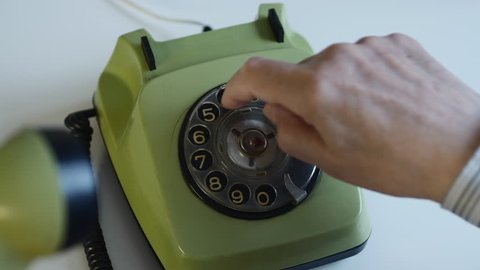 Man Dialing A Number On A Vintage Retro Rotary Phone