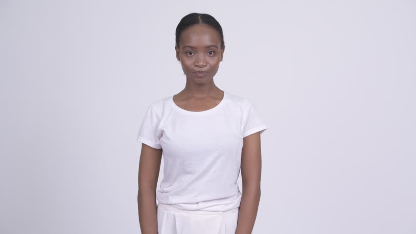 Young beautiful African woman against white background