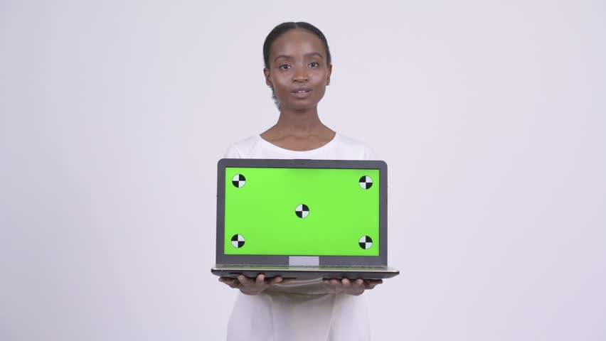 Happy young beautiful African woman showing laptop