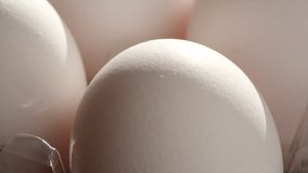 Close up footage of white chicken eggs on wooden table. Selective focus.
