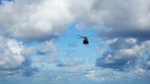Helicopter heading and landing on an offshore oil rig , service travel to oil and gas platform and drilling rig in offshore locations
