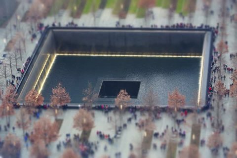 Miniature People visiting the reflecting pools at the 9/11 Memorial New York, United States of America.