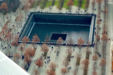 Miniature People visiting the reflecting pools at the 9/11 Memorial New York, United States of America.