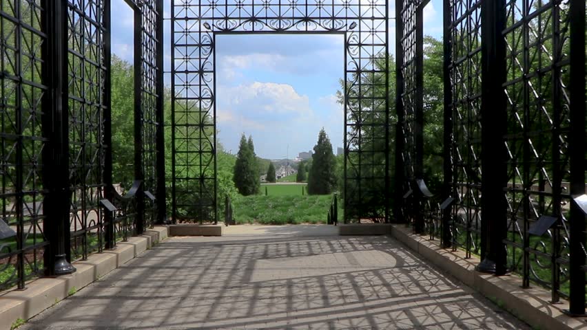 Walking through a gate into a symmetrical field in city park Chicago