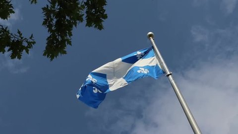 Québec, Canada - 07 15 2018: Quebec flag seen from below, waving in the wind