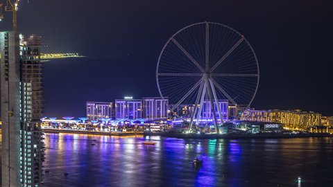 Bluewaters island aerial night timelapse with ferris wheel, new walking area with shopping mall and restaurants, newly opened leisure and travel spot in Dubai