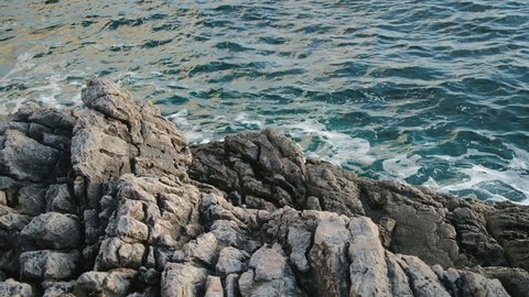 Rocks and azure sea in Montenegro at sunset
