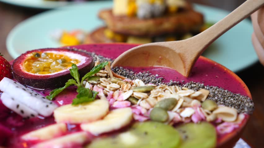 Eating Healthy Breakfast Bowl. Acai Smoothie, Granola, Seeds, Fresh Fruits. Clean Eating, Dieting, Detox, Vegetarian, Vegan Food Concept. Royalty-Free Stock Footage #1022025031