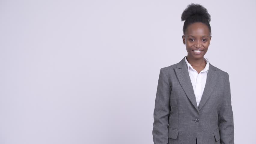 Young happy African businesswoman showing something