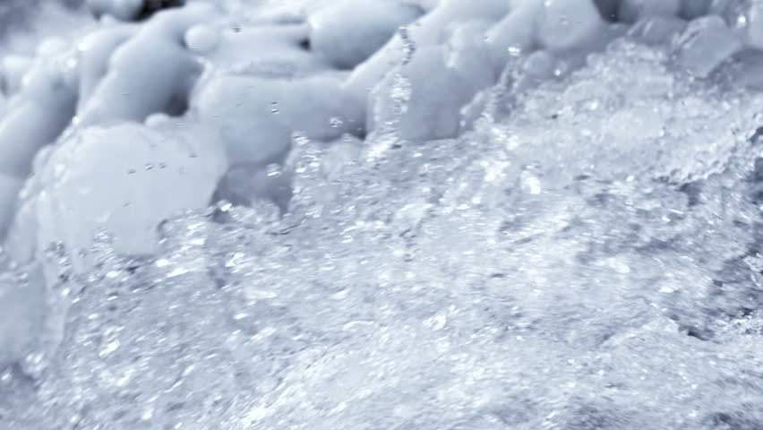 Crystal water from the waterfall  with ice in winter time. Close up slow motion footage. | Shutterstock HD Video #1022033581