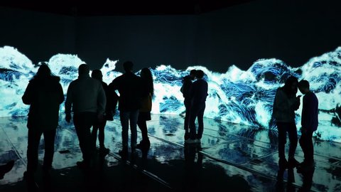 HELSINKI, FINLAND - JAN 06, 2019: "Massless" Exhibition - immersive interactive graphic digital installations by Japanese artists TeamLab at Amos Rex Museum. Visitors enjoy the new modern digital art.