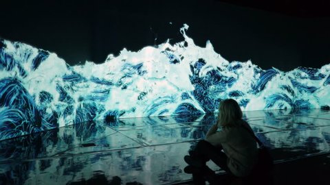 HELSINKI, FINLAND - JAN 06, 2019: "Massless" Exhibition - immersive interactive graphic digital installations by a group of Japanese artists TeamLab at the Amos Rex Museum. Visitors at museum enjoy