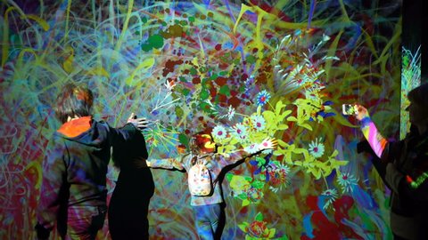 HELSINKI, FINLAND - JAN 06, 2019: "Massless" Exhibition - immersive interactive graphic digital installations by a group of Japanese artists TeamLab at the Amos Rex Museum. Children and adults enjoy