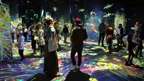HELSINKI, FINLAND - JAN 06, 2019: "Massless" Exhibition - immersive interactive graphic digital installations by Japanese artists TeamLab at Amos Rex Museum. Visitors enjoy the new modern digital art
