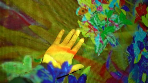 HELSINKI, FINLAND - JAN 06, 2019: "Massless" Exhibition - immersive interactive graphic digital installations by Japanese artists TeamLab at Amos Rex Museum. Visitors enjoy the modern digital art