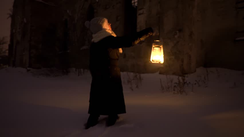 Girl standing in front of church with a oil lamp