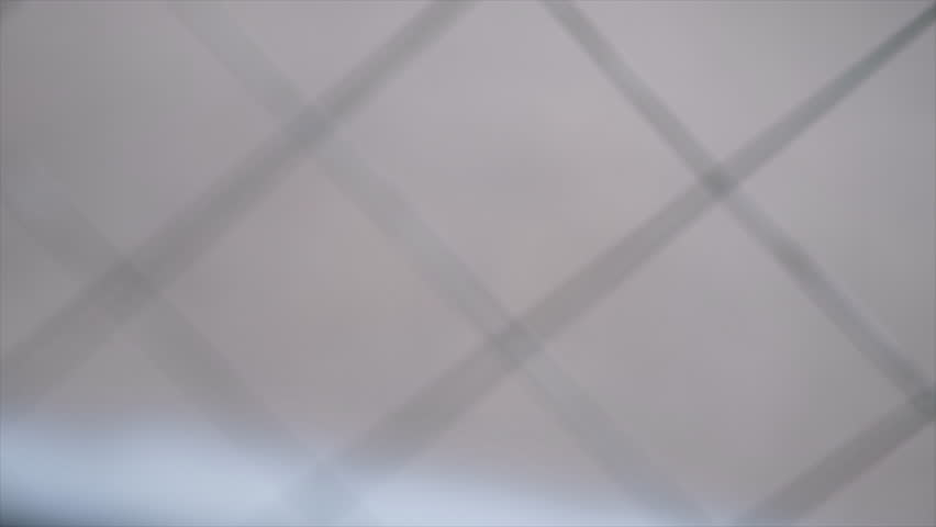 Small magnetic compass by the window. Tilt down footage, selective focus.