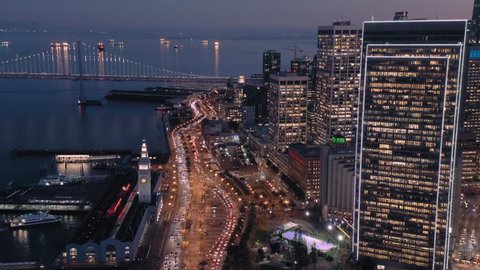 Aerial Drone Of The San Francisco City Skyline, Ferry Terminal and ferries at night.