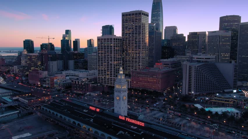 Aerial Drone Of The San Francisco City Skyline and Ferry Terminal at night.