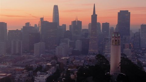 Aerial: Coit Tower, Telegraph Hill and the San Francisco city skyline at sunrise 