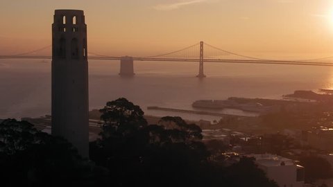 Aerial: Coit Tower, Telegraph Hill and the San Francisco city skyline at sunrise