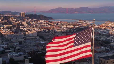 Aerial: American Flag flapping in the wind. San Francisco, USA