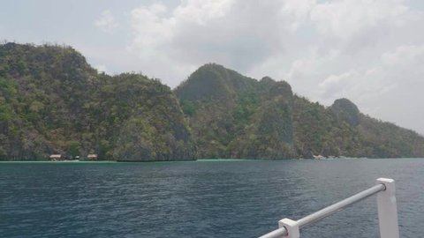 Permian Limestone Mountains In Tropical Archipelago With Steep Cliffs Surrounded by Blue Ocean. 4K Slow Motion.