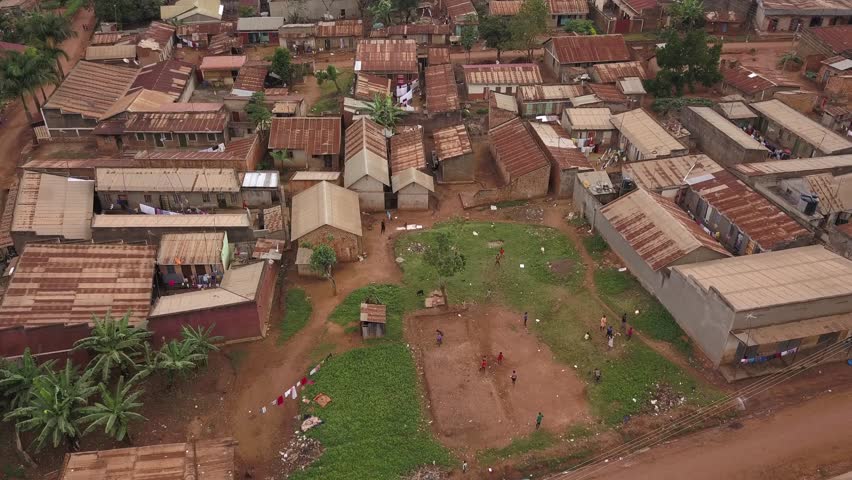 A moving forward aerial shot over a slum village in Africa. | Shutterstock HD Video #1022069296