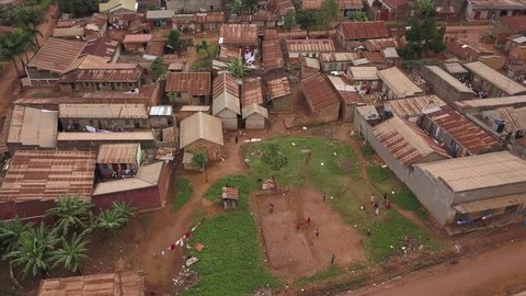 Aing forward aerial shot over a slum village in Africa.