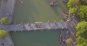 Aerial view of Hoi An old town or Hoian ancient town. Royalty high-quality free stock footage top view of bridge on river and boat traffic Hoi An. HoiAn is one of the most popular destination  travel