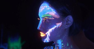 Portrait of Beautiful Fashion Woman in Neon UF Light. Model Girl with Fluorescent Creative Psychedelic MakeUp, Art Design of Female, Colorful Abstract Make-Up. Dancing Lady - Powered by Shutterstock - Get 15% off with code: PIKWIZARD15