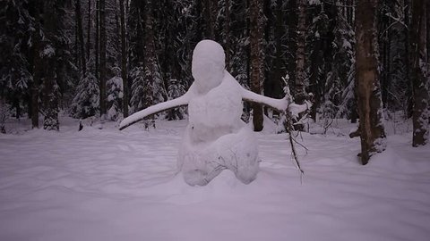Snowman in the snow-covered forest