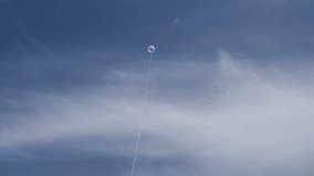 Balloons on long strings in the blue sky.
Video footage of balloons on long strings.